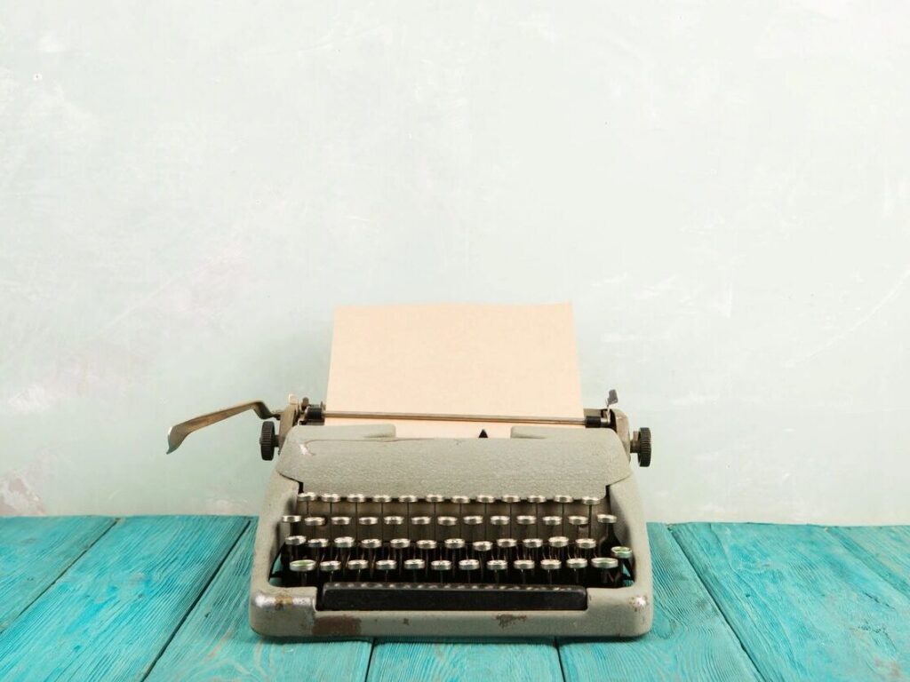 Vintage typewriter on a wooden desk with warm lighting, representing personal storytelling and memoir writing.